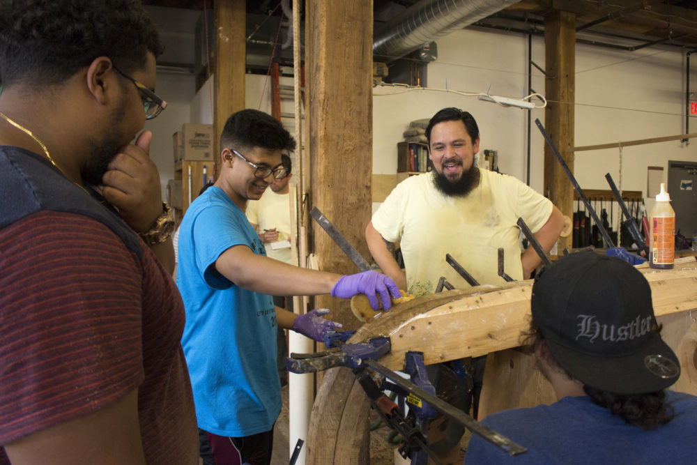 Jesus Castro works with kids at the Philadelphia Wooden Boat Factory.