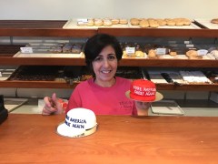 Traub's Bakery Decorator Deneen Ciancaglini stands with her creation, Make America Great Again hat cakes.