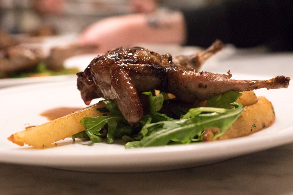 Grilled quail glazed with an orange juice-Jamaican rum sauce over duck fat potatoes and arugula