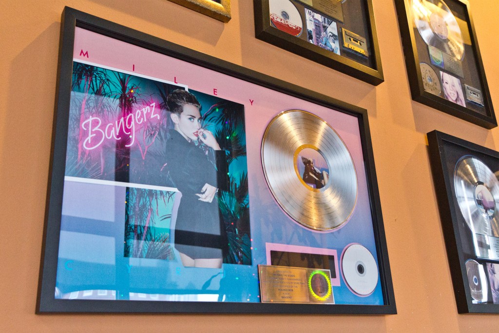 A golden record commemorates the sale of 1 million copies of Miley Cyrus’ Bangerz album which was record at the MilkBoy studios in Philadelphia. (Kimberly Paynter/WHYY)