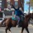 13-year-old Nahye Hyman raises a fist on his horse Sally during a GOTV ride down 52nd Street