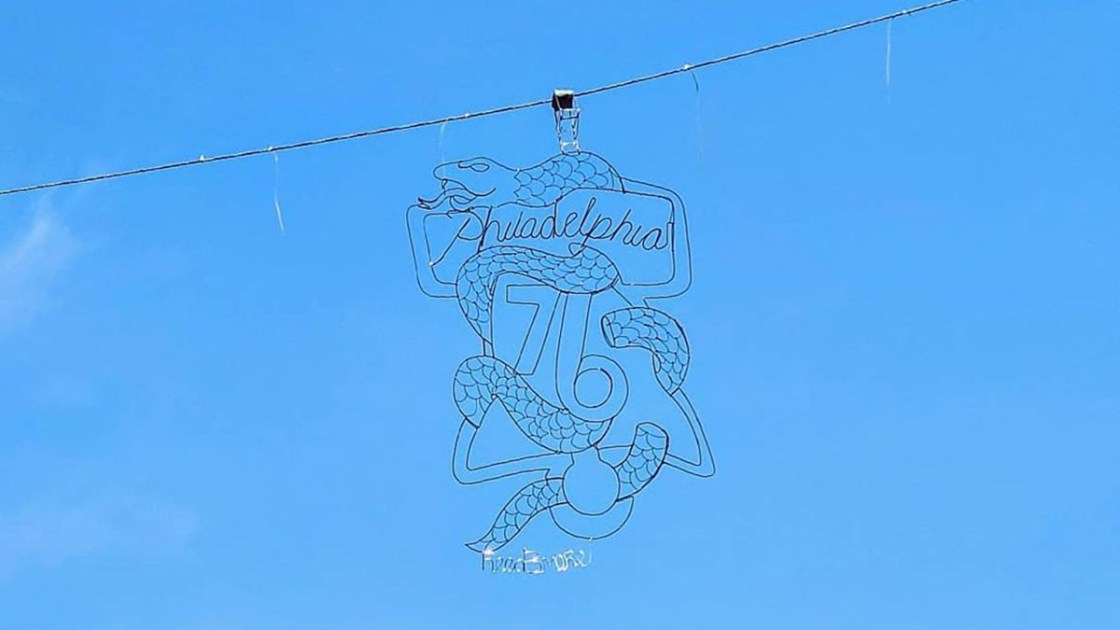 There's a giant Sixers logo hanging in the air, thanks to street