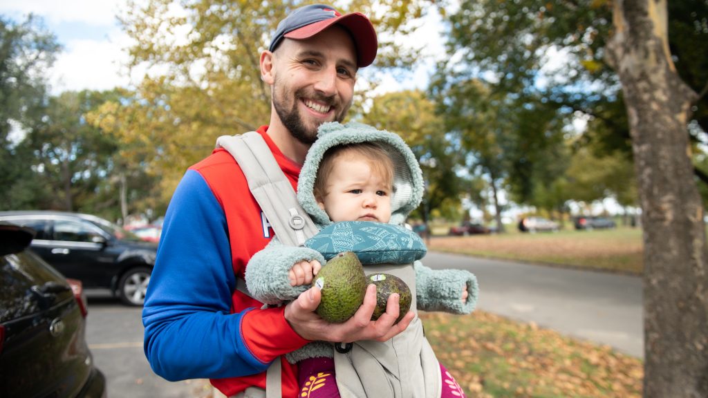 Philly resident Jake Madeira and his 9-month-old daughter Marlowe pose with their free avocados